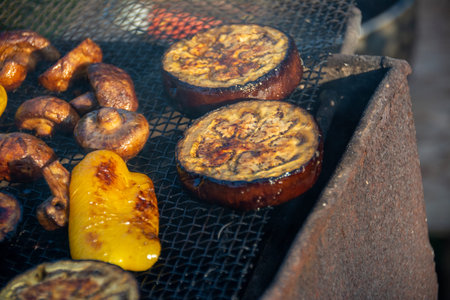 Grilled vegetables, appetizing on charcoal. Mushrooms, bell peppers and zucchini.