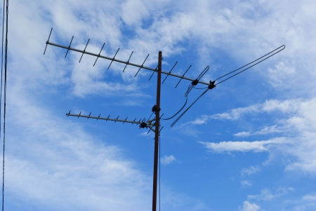 Home advance TV antenna on blue skyの写真素材