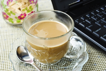 a cup of coffee and a laptopの写真素材