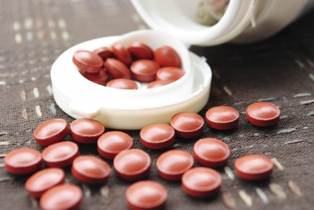 Vitamin pills an pill bottle on white backgroundの写真素材