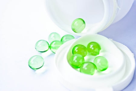 pills an pill bottle on white backgroundの写真素材