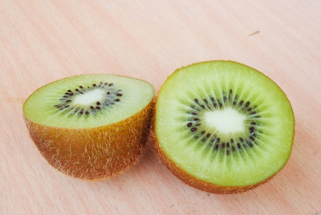 Fresh kiwis on wooden groundの写真素材