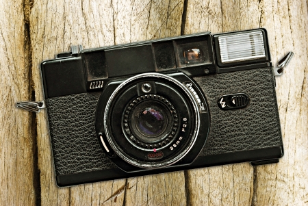 Vintage photo camera on a wooden tableの写真素材
