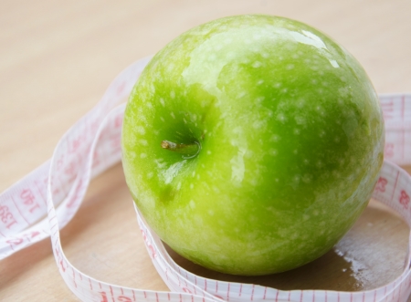 Green apple core and measuring tape. Diet conceptの写真素材