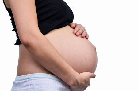 Woman holding her pregnant belly  White background 
