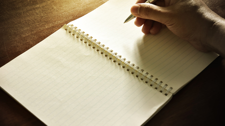 Notebook with pen on wooden table, Vintage picture toneの写真素材