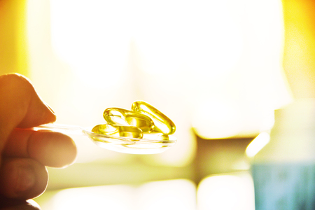 Cod liver oil omega 3 gel capsules in the spoon. Medicine, Medical health care, Healthy Foodの写真素材
