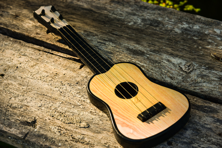 Toy acoustic guitar on vintage wood background, Close-upの写真素材