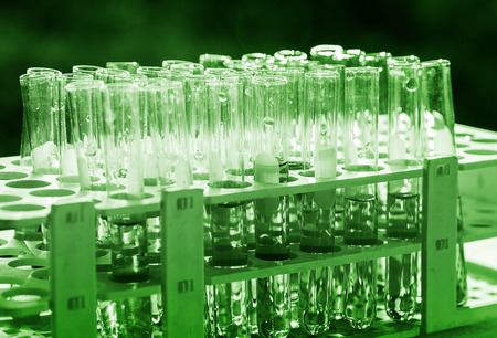 Lab science research glass items adding drop to one of several test tubes. A scientific experiment in a science research Laboratory.の写真素材