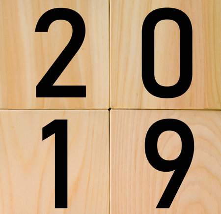 Business and success concept - surreal abstract geometric floating wooden cube with word 2019...