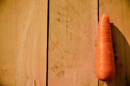 Fresh carrots with leaf on wooden floorの写真素材