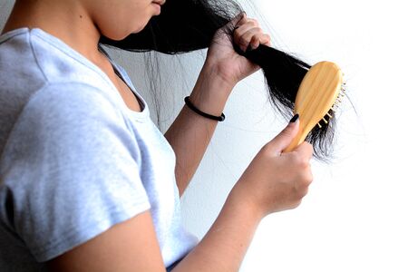 Hair loss, hair fall everyday serious problem, girl with a comb and problem hair.の写真素材