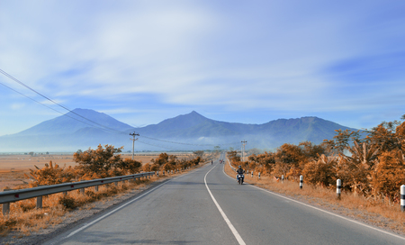 the road is quiet with a beautiful mountain backgroundの写真素材