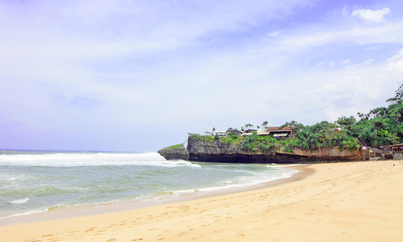 natural views of the south coast in the Yogyakarta region. This beach is named "Drini beach". This beach is white sand, next to it are cliffs and many rocks.の写真素材