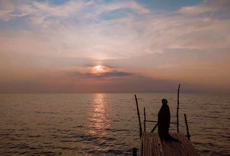 Sunset on the beach, Silhouette of people by the beachの写真素材