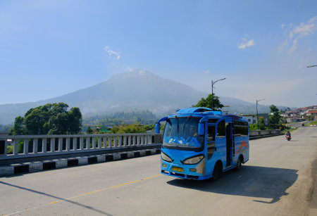 Temanggung, Indonesia - 07 November 2020: Bus speeding on highway, Bus on highway with mountains background, Bus on roadのeditorial素材