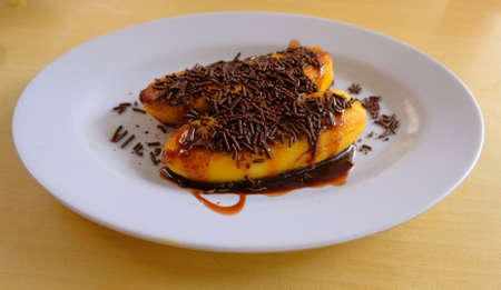 Banana caramel with chocolate sprinkles on the tableの写真素材