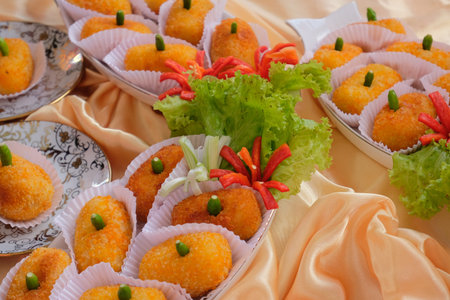 Kroket kentang is a traditional snack from Indonesia. served in wooden plate with green chilli....