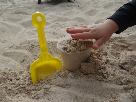 Child play in sandの写真素材