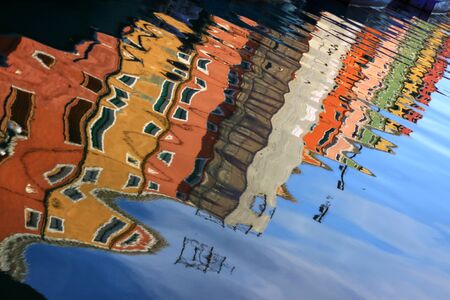 The reflection of the colorful town in the water.の写真素材