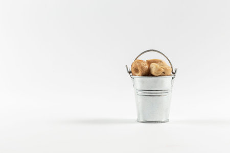 Small cooked snacks in an iron retro bucket. Proper nutrition. On white backgroundの写真素材