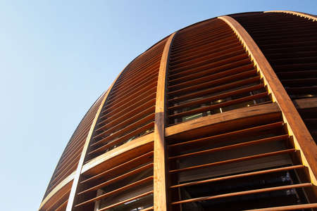 A semicircular wooden dome with horizontal lines against a blue sky. 01.2020 Milan.のeditorial素材