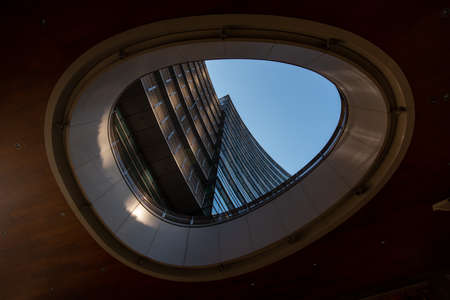 Milan, Italy, March 2020. Window in the window with a view of the multi-storey building. Window color dark wood. Milan 01.20のeditorial素材