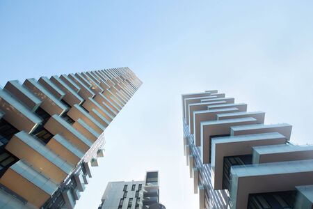 Buildings with large balconies are beautifully in harmony with each other in white against a blue sky.の写真素材