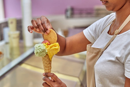Cookies on ice cream. The seller in shop.