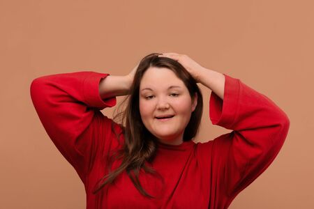 A beautiful young girl posing in front of the camera. an overweight girl.の写真素材