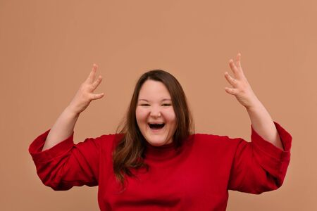 An overweight girl. A cheerful girl. Bright jacket. Bright clothes.の写真素材