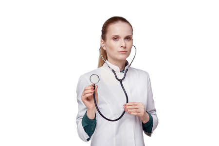 Close-up face of a female doctor and phonendoscope looking at the camera. White isolated background.の写真素材