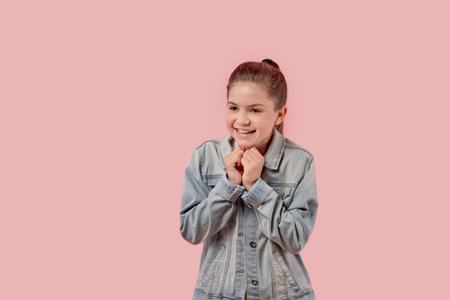 Portrait of a beautiful cute smiling girl. Pink background.