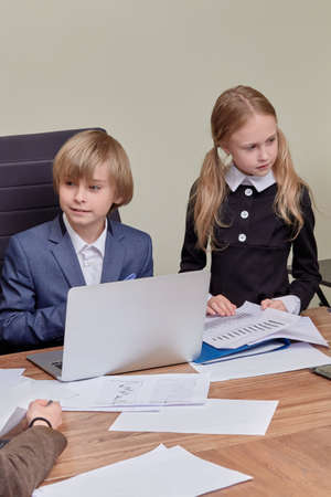 Group of business workers, smiling, happy and confident. We work together with a smile on our face. Young handsome blond boy, sitting at the table and listening attentively.の写真素材