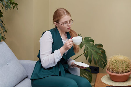 Beautiful young confident business woman with coffee in her hands. Lunch break.の写真素材