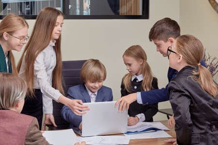 Corporate business team and manager at a meeting. office cabinet. The kids are businessmen.の写真素材