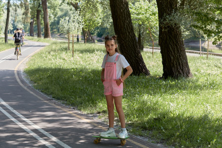 Portrait of a young beautiful girl on a bright sunny day. Cheerful contented girl. Summer day.
