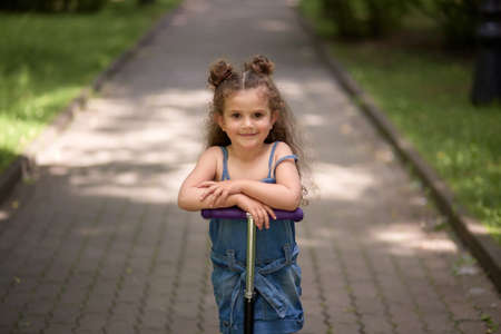 Portrait of a young beautiful girl on a bright sunny day. Cheerful contented girl. Summer day.の写真素材