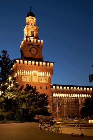 Sforza Castle with a fountain at night. Beautiful illumination of the building in warm colors. Milan Italy 08.2020のeditorial素材