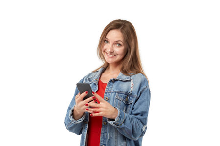 Happy young woman smiles and looks at the screen. White isolated background.
