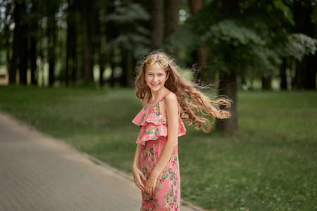 Portrait of a beautiful fashionable girl in pink clothes and sunglasses. The path is tiled.の写真素材