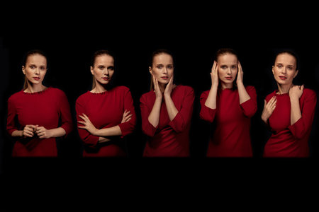 Isolated young beautiful woman in red dress on black background. The concept of beauty.