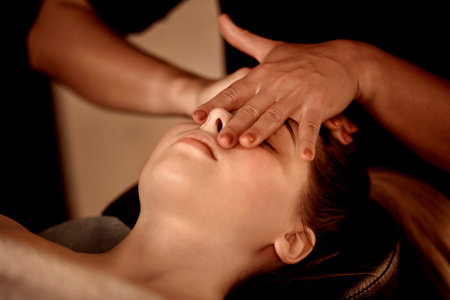 Massage against runny nose and nasal congestion. Healing facial massage in a beauty salon. Wellness...