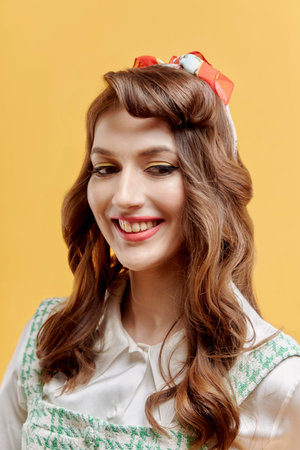 Close-up portrait of a beautiful young woman with bright makeup and a snow-white smile. Red...