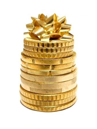 Holiday Spending - Stack of Coins with Gift Bow on top の写真素材