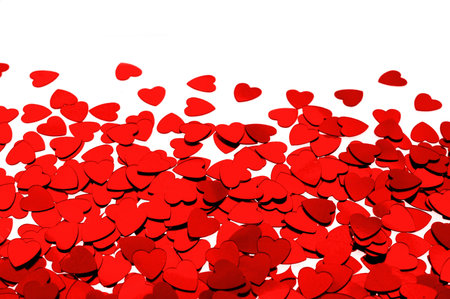 Red heart shaped confetti background or horizontal border over whiteの写真素材