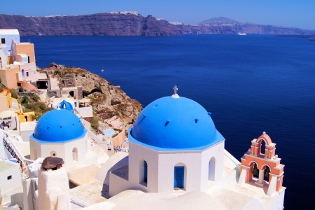 Famous blue dome churches of Santorini, Greece overlooking the scenic calderaの写真素材