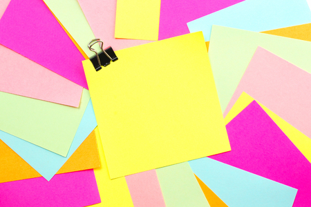 Blank post it note with paper clip and colorful backgroundの写真素材