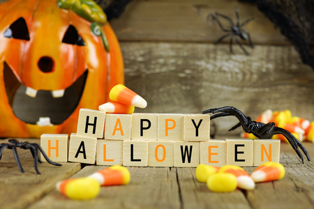 Happy Halloween wooden blocks with candy corn and decor against an old wood backgroundの写真素材