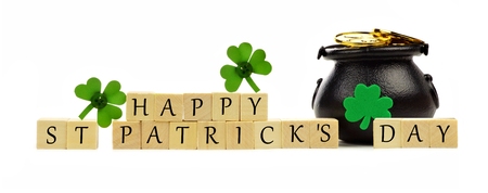 Happy St Patricks Day wooden blocks with Pot of Gold and shamrocks over whiteの写真素材